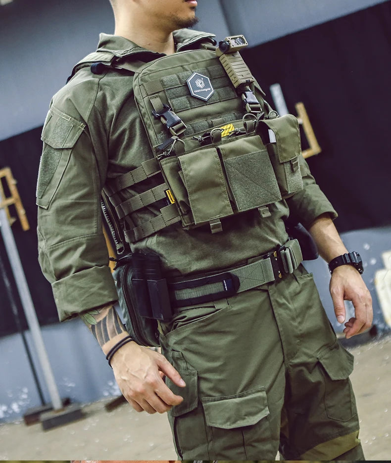 Military combat shirt in olive green worn by a person equipped with tactical gear for outdoor activities