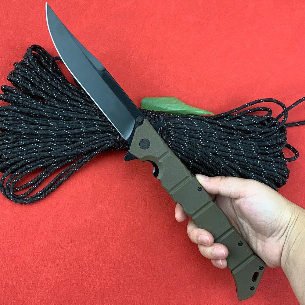 Professional survival knife with ergonomic handle and black blade alongside paracord for outdoor activities