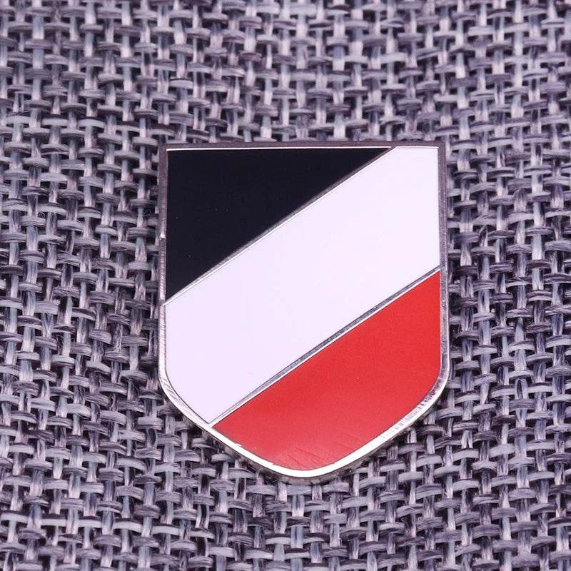 WWII German helmet badge in a shield shape with black, white, and red colors