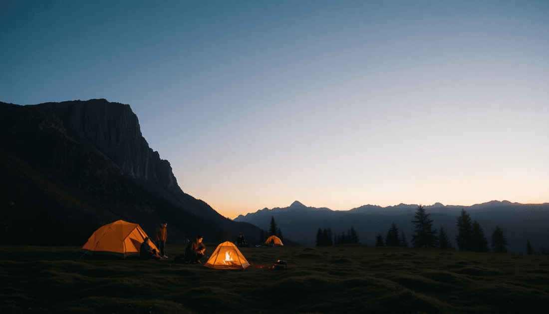 Camping setup with glowing tents at dusk in mountainous terrain featuring top military camping gear