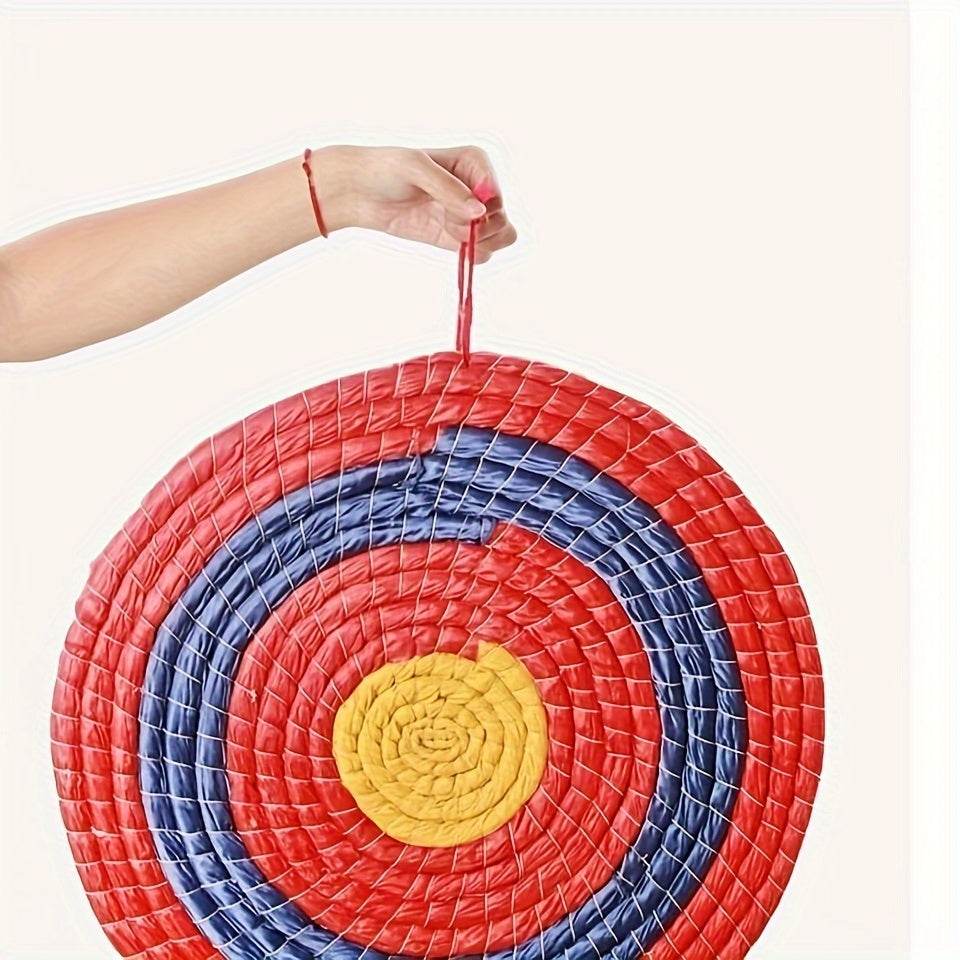 Colorful woven grass archery target with red, blue, and yellow concentric circles for practice