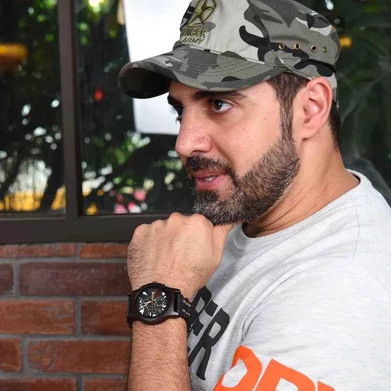 Stylish wooden military watch showcased on a man's wrist, worn with a casual outfit and camo cap
