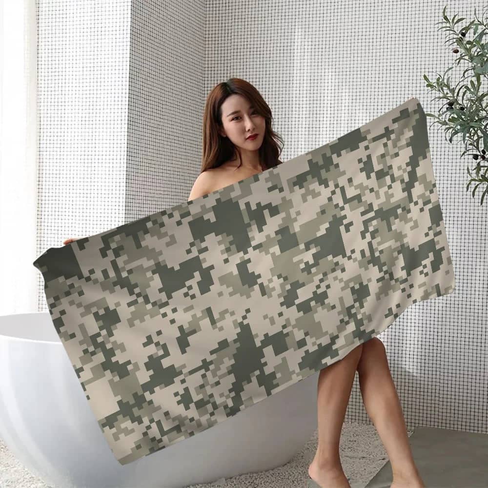 Camouflage beach towel displayed by a model, ideal for outdoor enthusiasts and beach lovers