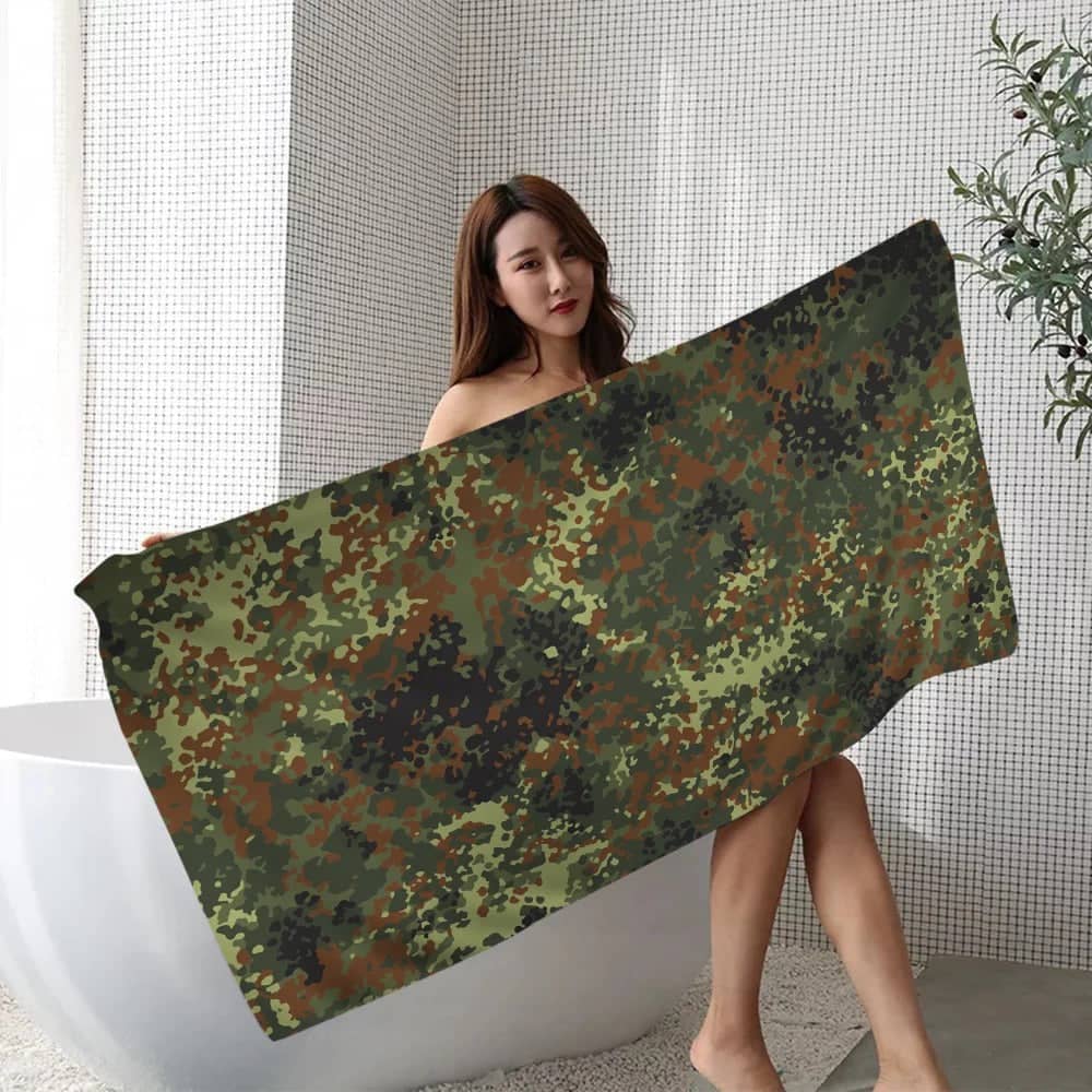 Camouflage beach towel in green and brown patterns, ideal for outdoor activities and relaxing by the water