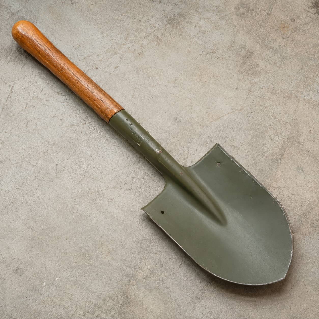 Chinese military surplus shovel with a wooden handle for outdoor utility