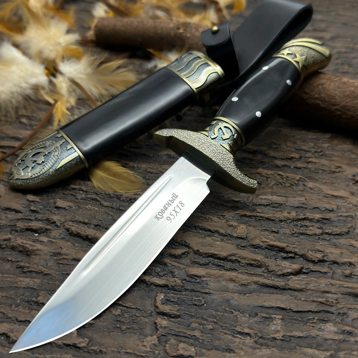 Finka NKVD knife with a detailed handle and black sheath for outdoor use