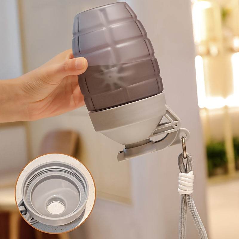 Hand holding a grenade shaped water bottle with a detachable cap for outdoor activities