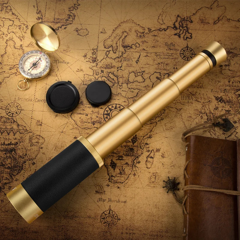 High-powered monocular telescope in gold and black with a vintage map and compass background