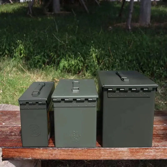 Set of three green military-style metal storage boxes in various sizes for outdoor organization