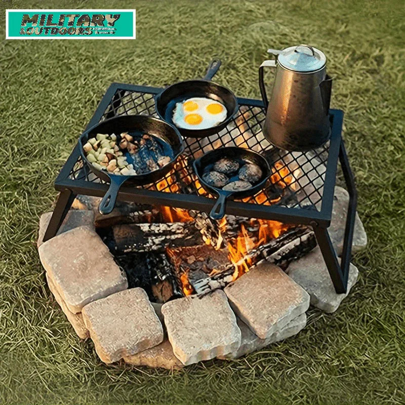 Outdoor bonfire grill with pots and pans cooking breakfast over a campfire on a stone circle