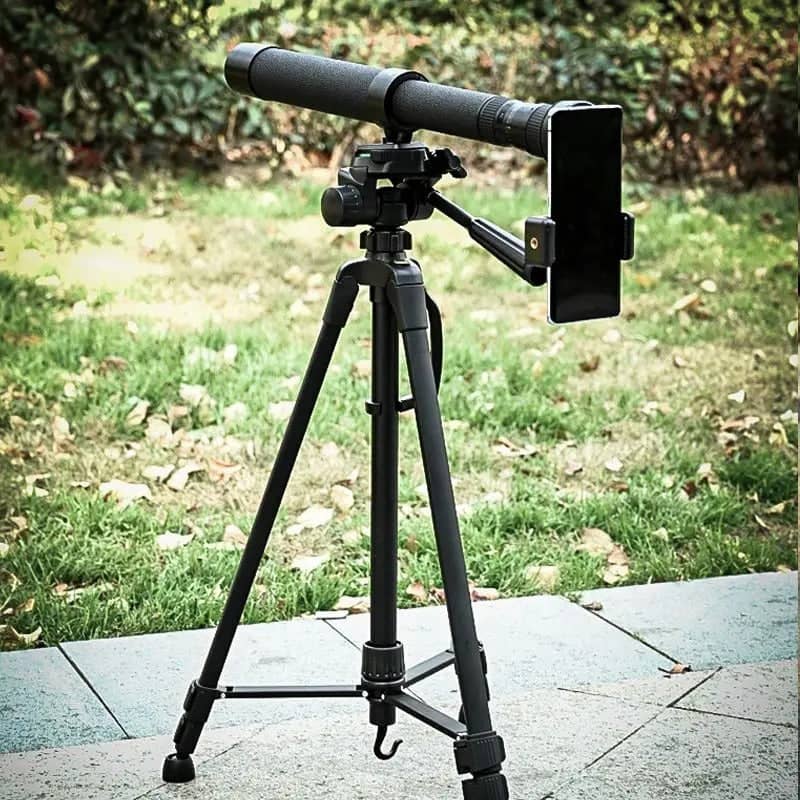 Black monocular telescope on tripod for outdoor viewing with smartphone support