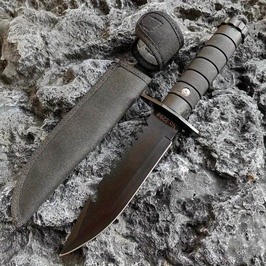 Black tactical hunting and camping knife with a serrated edge and durable sheath