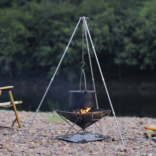 Outdoor tripod cookware stand for camping over an open fire near a river