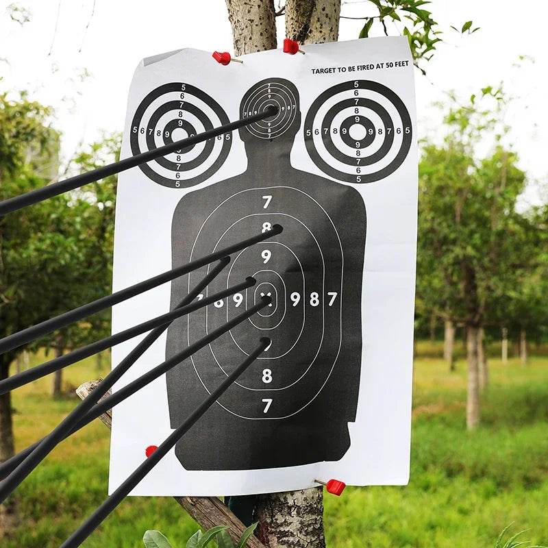 Paper silhouette target with multiple arrow impacts for accurate shooting practice