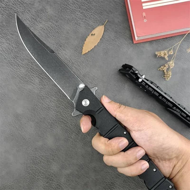 Professional survival knife with a sleek black handle for outdoor use
