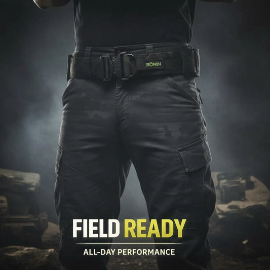 Person wearing tactical pants with a outdoor belt, standing in a dark, smoky environment.
