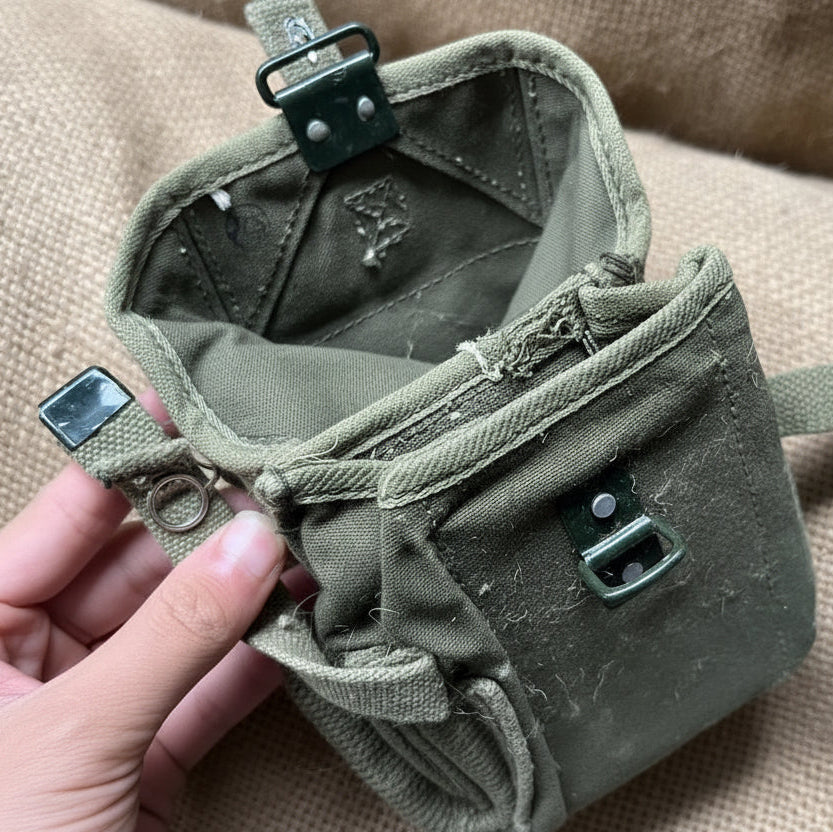 Green military surplus pouches for outdoor storage and gear organization