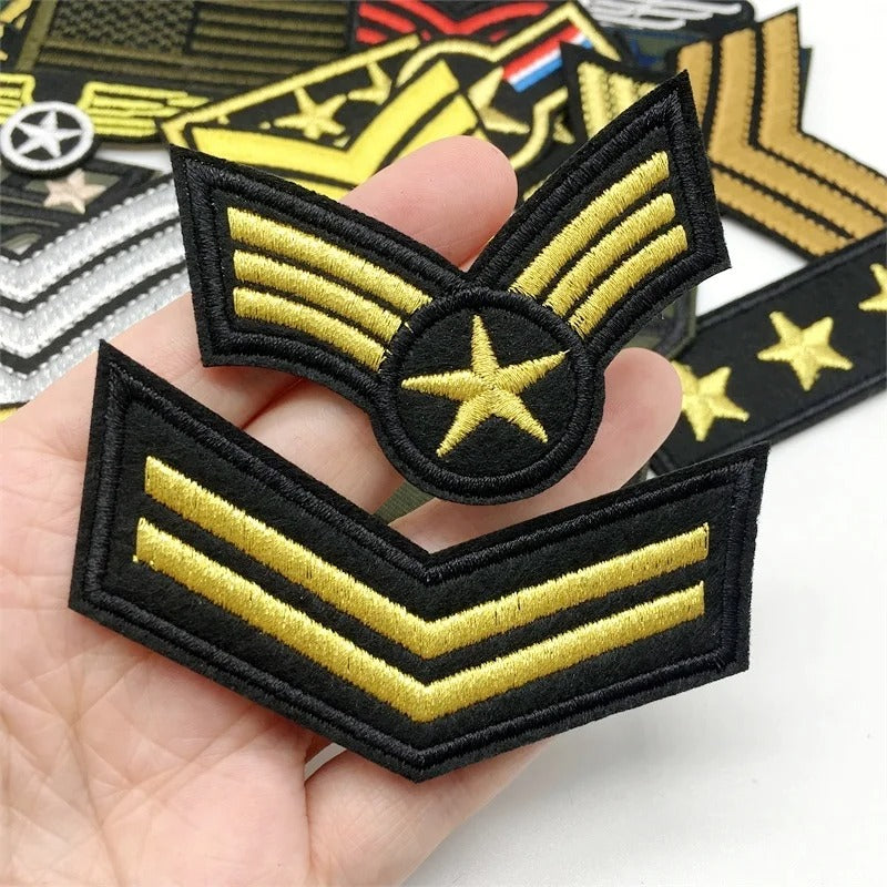 Set of tactical military patches featuring gold stripes on a black background for uniform customization
