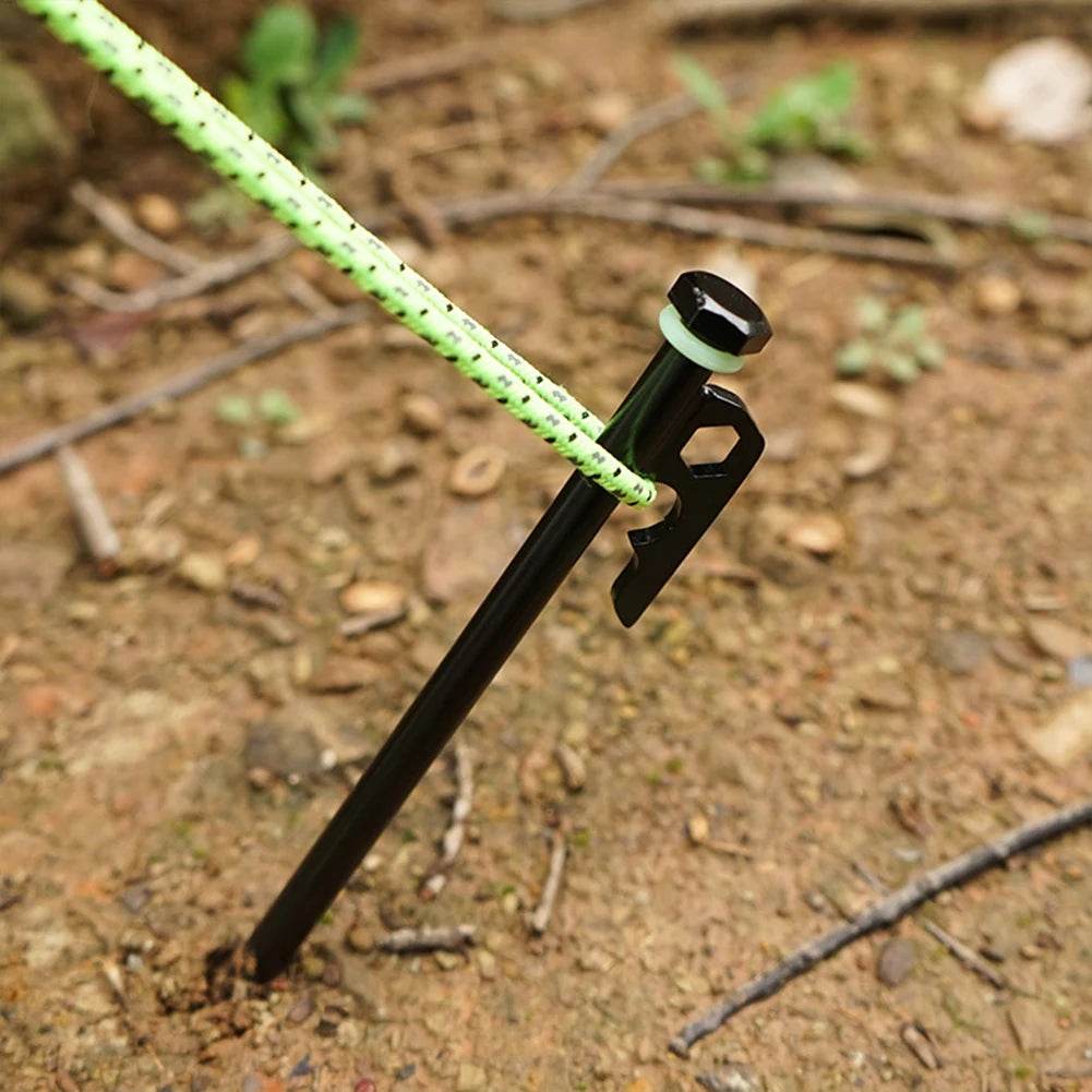 Black tent peg with rope for secure outdoor camping setup