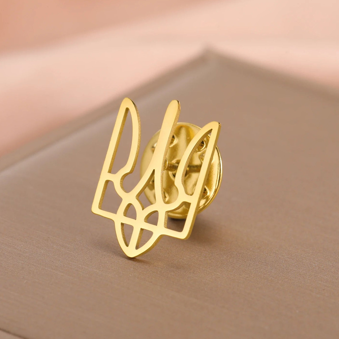 Ukraine symbol pin in gold, a stylish accessory for showing support