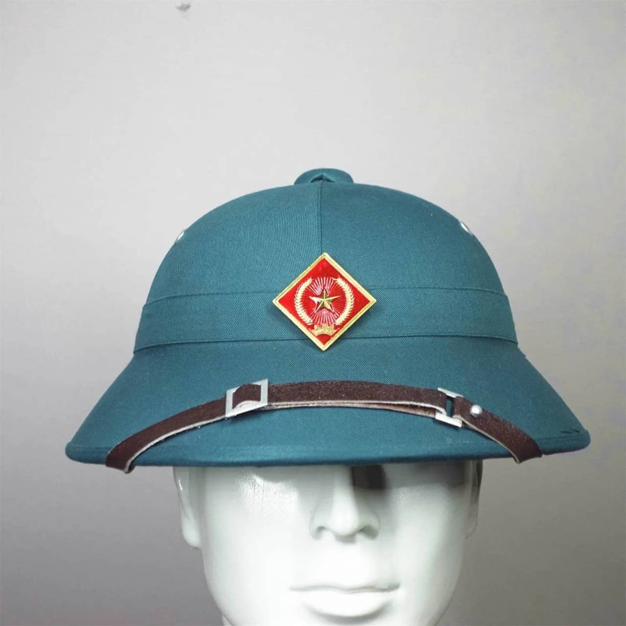 Vietnam surplus military helmet in teal with badge for collectors