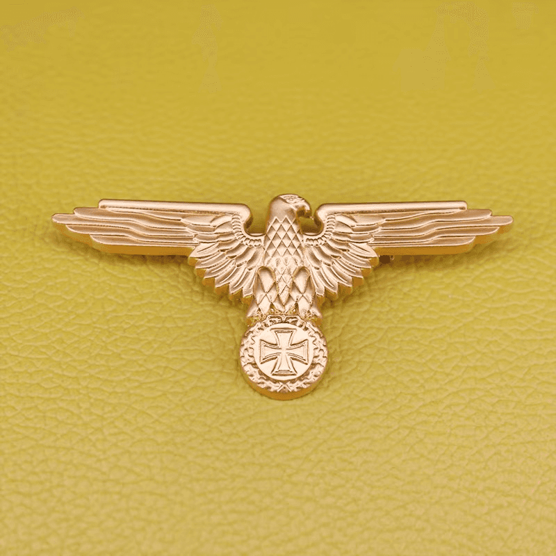 Gold WW2 German Luftwaffe badges featuring an eagle design on a textured background