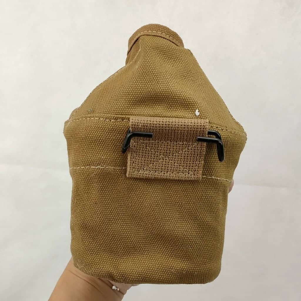 WWII marine canteen kettle in tan color, designed for outdoor cooking and camping